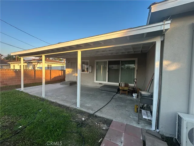 a view of backyard with patio