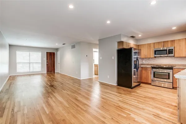a view of kitchen electric appliances and wooden floor