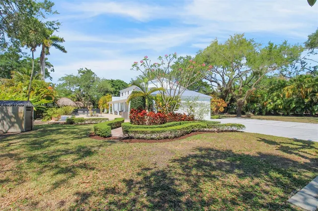 a backyard of a house with table and chairs