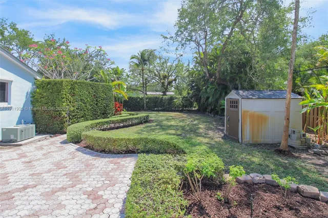 a view of a house with yard and sitting area