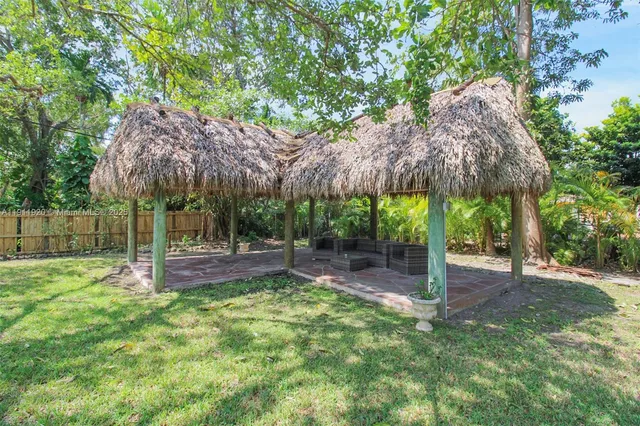 a view of a dining room with furniture and a potted plant