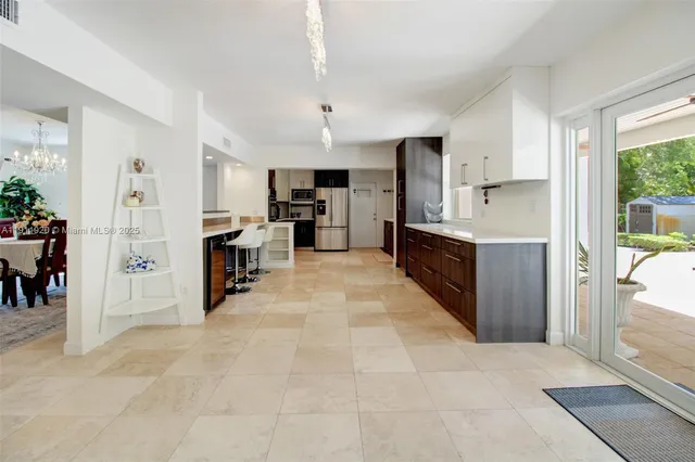 a kitchen with stainless steel appliances a refrigerator sink microwave and cabinets