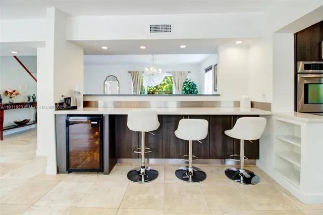 a open kitchen with white cabinets and stainless steel appliances