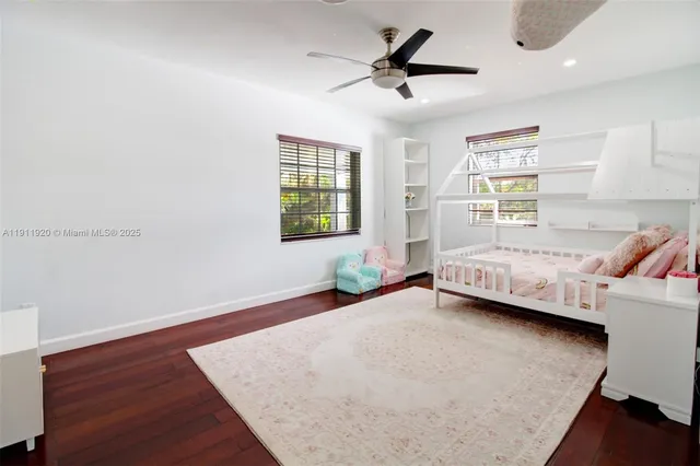 a bedroom with a bed a table and chair