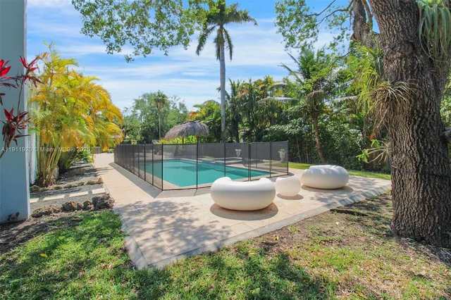 a view of a backyard with garden and patio