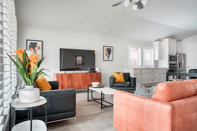 a living room with furniture and a lamp