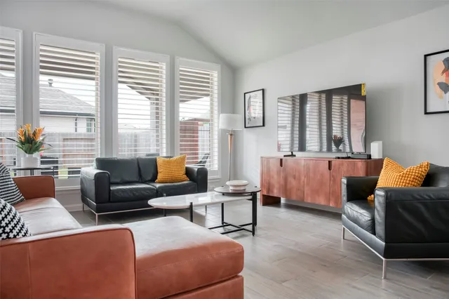 a living room with furniture and windows