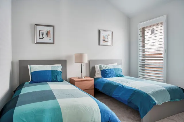 a bedroom with two beds and a window