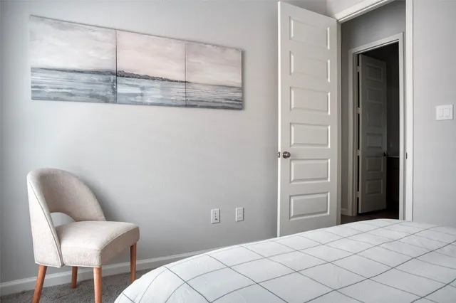 a bedroom with a chair and a chair