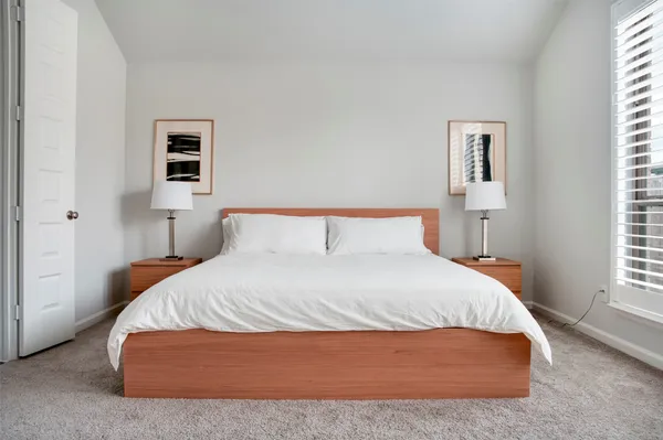 a bedroom with a bed and window