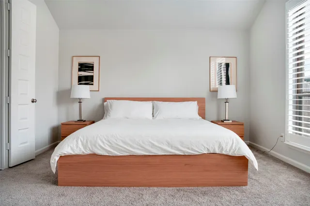 a bedroom with a bed and window