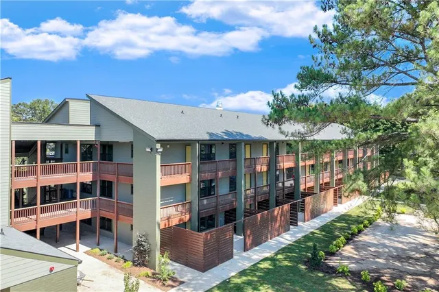 a view of a large building with a big yard and large trees