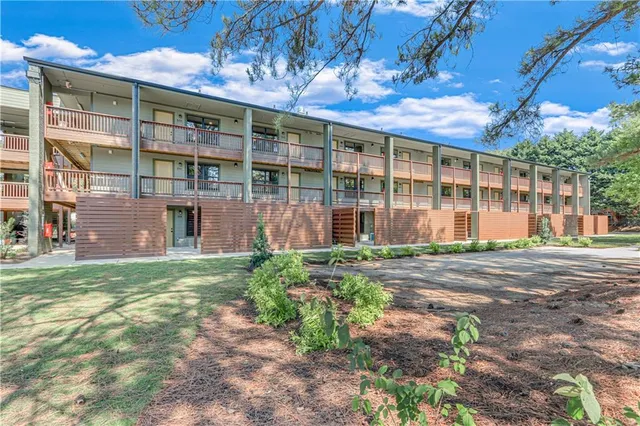 a front view of a building with a garden