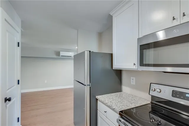 a kitchen with a refrigerator and a stove