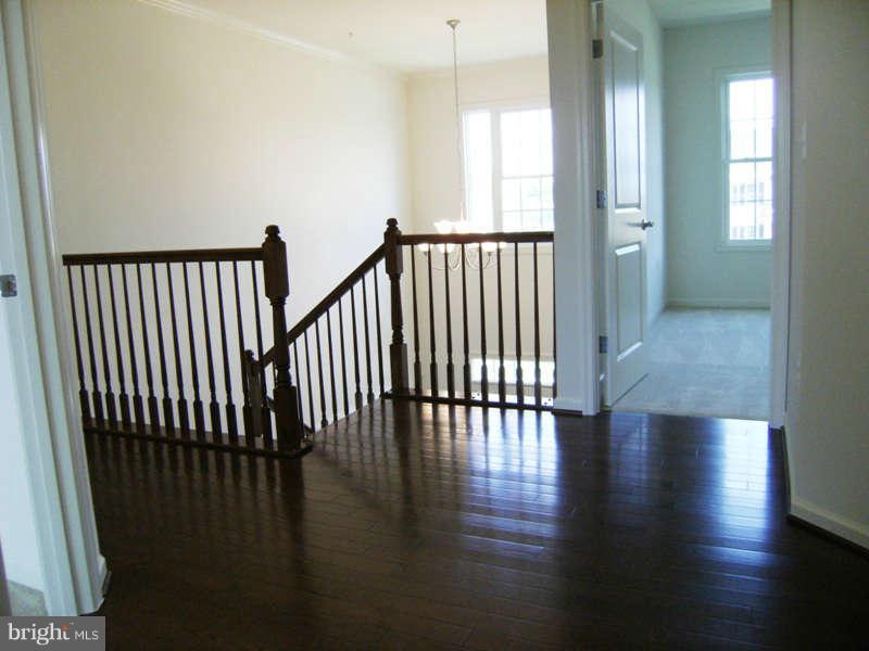 13333 Redspire Drive Silver Spring, MD 20906 - Photo 11 of 30 a view of a hallway with wooden floor and windows