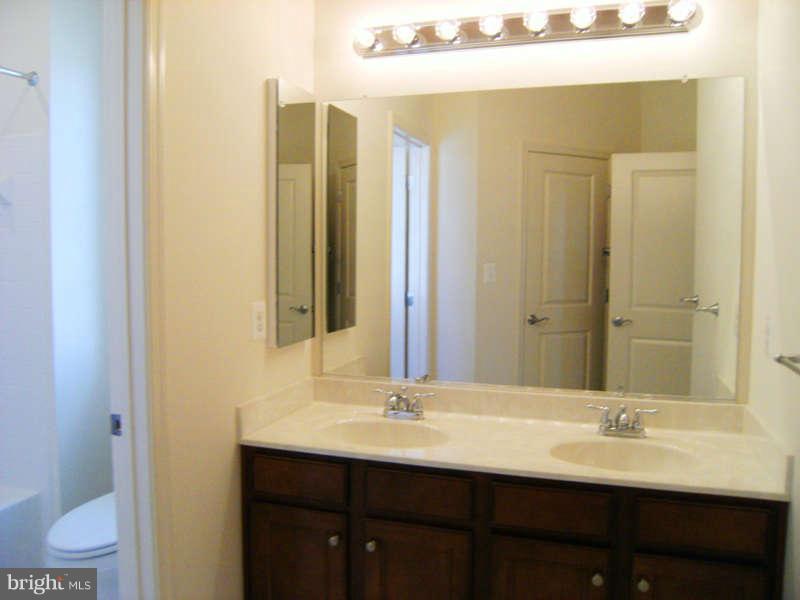 13333 Redspire Drive Silver Spring, MD 20906 - Photo 14 of 30 a bathroom with a double vanity sink and a mirror