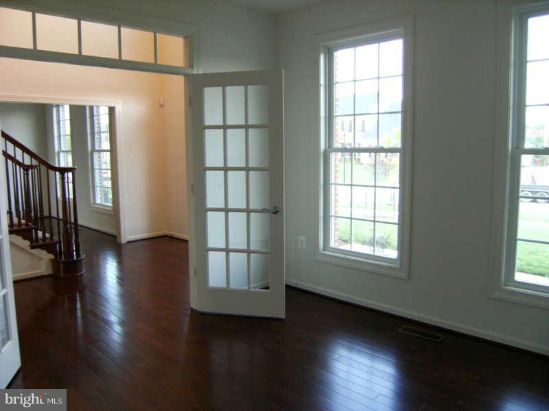 13333 Redspire Drive Silver Spring, MD 20906 - Photo 4 of 30 an empty room with wooden floor and windows