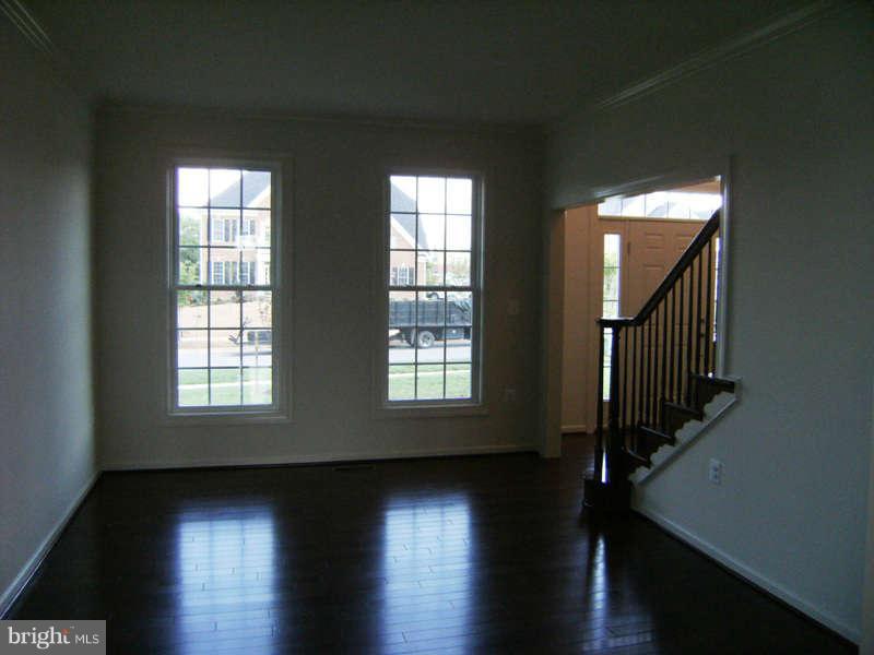 13333 Redspire Drive Silver Spring, MD 20906 - Photo 5 of 30 a view of empty room with wooden floor and fan
