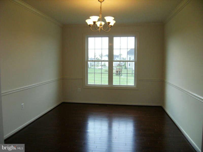 13333 Redspire Drive Silver Spring, MD 20906 - Photo 6 of 30 an empty room with wooden floor and windows