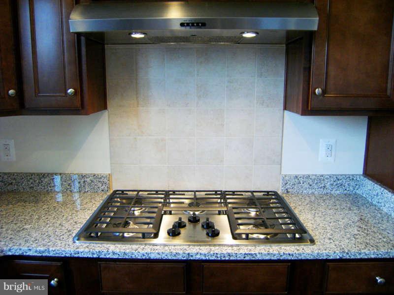 13333 Redspire Drive Silver Spring, MD 20906 - Photo 9 of 30 a white stove top oven sitting inside of a kitchen