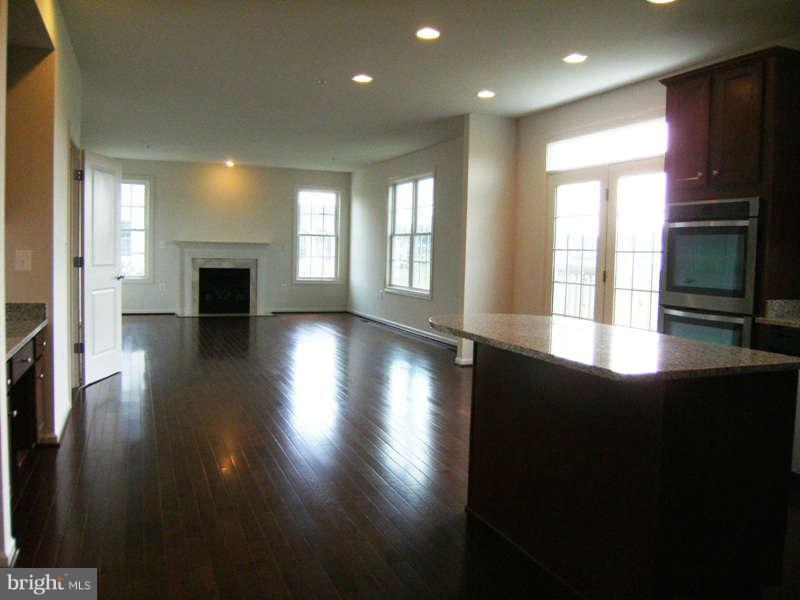 13333 Redspire Drive Silver Spring, MD 20906 - Photo 10 of 30 a view of a living room with fireplace and wooden floor