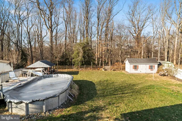 a swimming pool with outdoor seating and yard