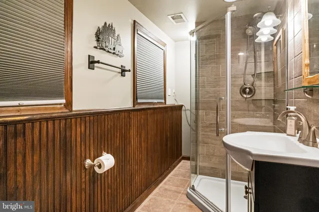 a bathroom with a sink a mirror and shower