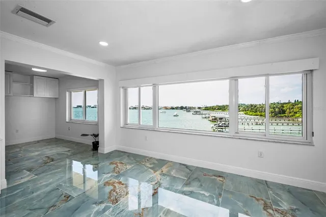 a view of a dining room with furniture a chandelier and wooden floor