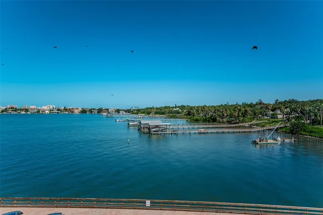a view of a lake with a table and chairs