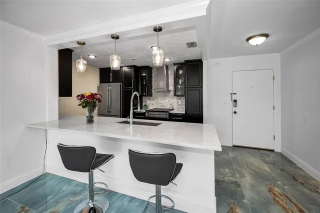 a kitchen with stainless steel appliances granite countertop a sink and a microwave