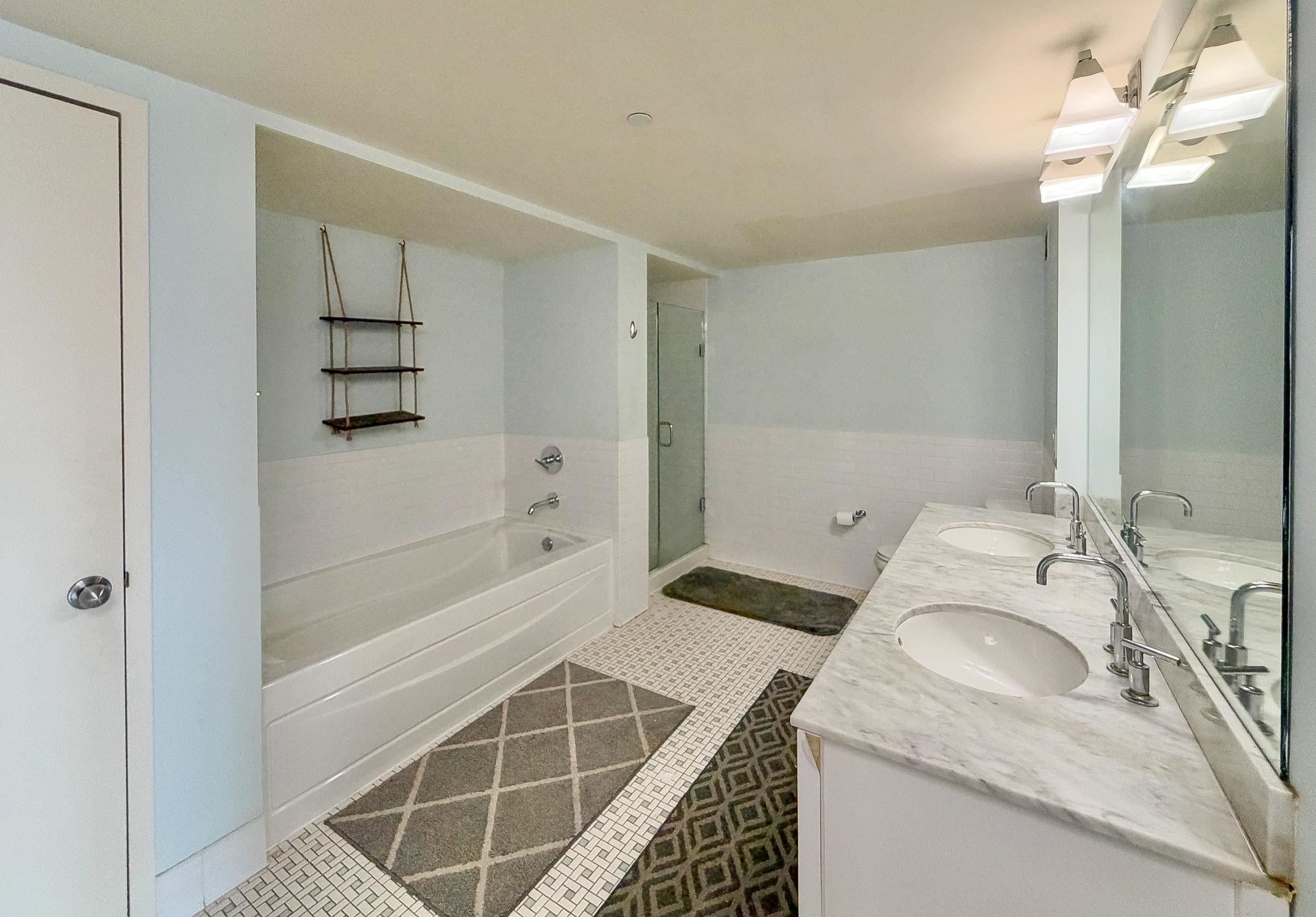 700 Grove Street, Unit 4F Jersey City, NJ 07310 - Photo 21 of 30 a bathroom with a granite countertop sink a toilet and shower