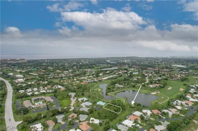 an aerial view of a golf course with ocean view