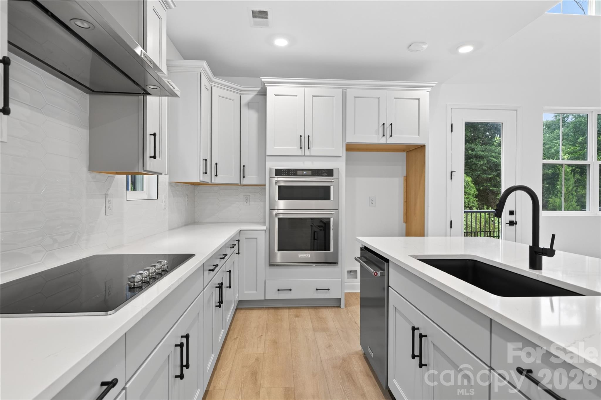 416 Celestial Drive Tega Cay, SC 29708 - Photo 3 of 21 a kitchen with stainless steel appliances a sink stove and refrigerator