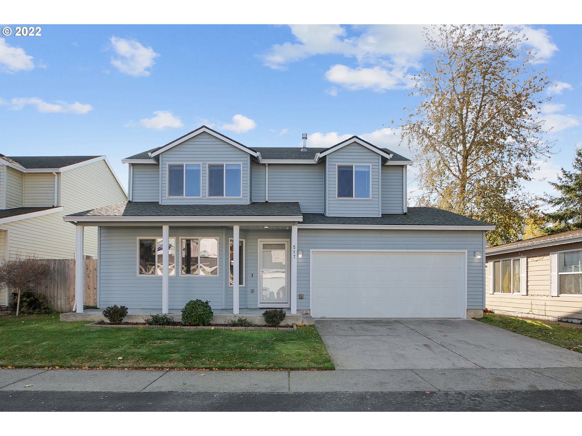 517 Northeast Mariners Loop Portland, OR 97211 - Photo 1 of 30 a front view of a house with a garden