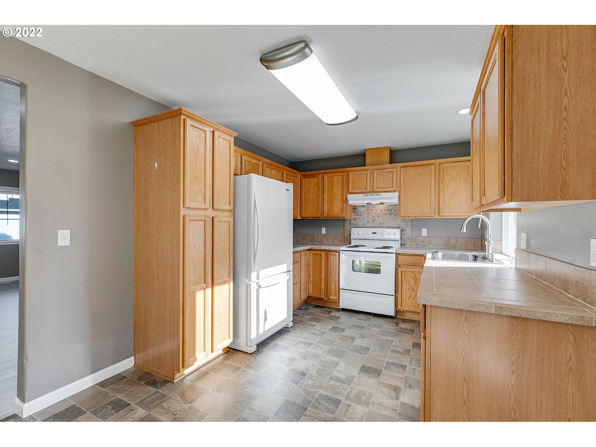 517 Northeast Mariners Loop Portland, OR 97211 - Photo 12 of 30 a kitchen with stainless steel appliances a stove a sink and a refrigerator
