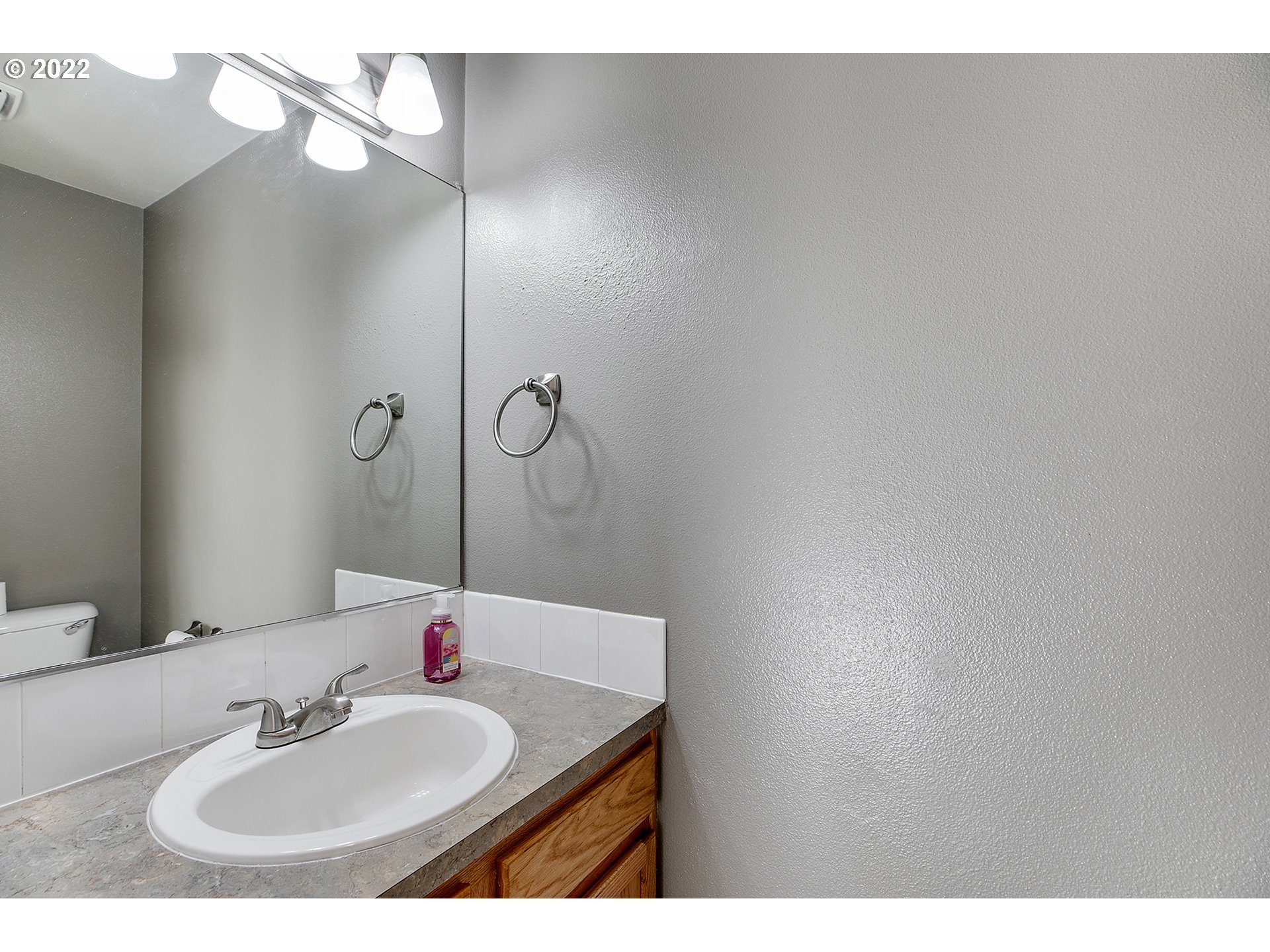 517 Northeast Mariners Loop Portland, OR 97211 - Photo 13 of 30 a bathroom with a sink and a mirror