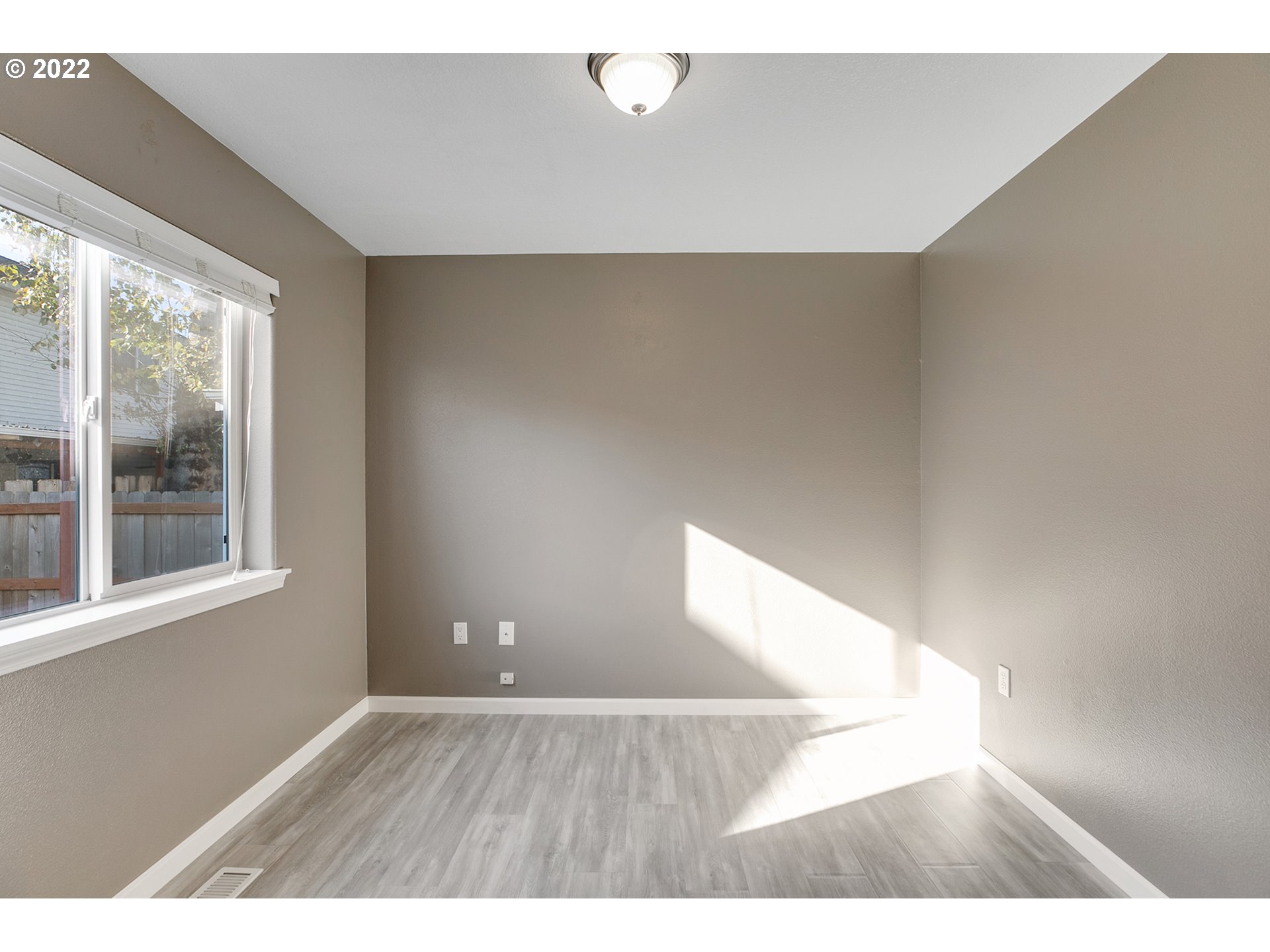 517 Northeast Mariners Loop Portland, OR 97211 - Photo 14 of 30 a view of an empty room with wooden floor and a window
