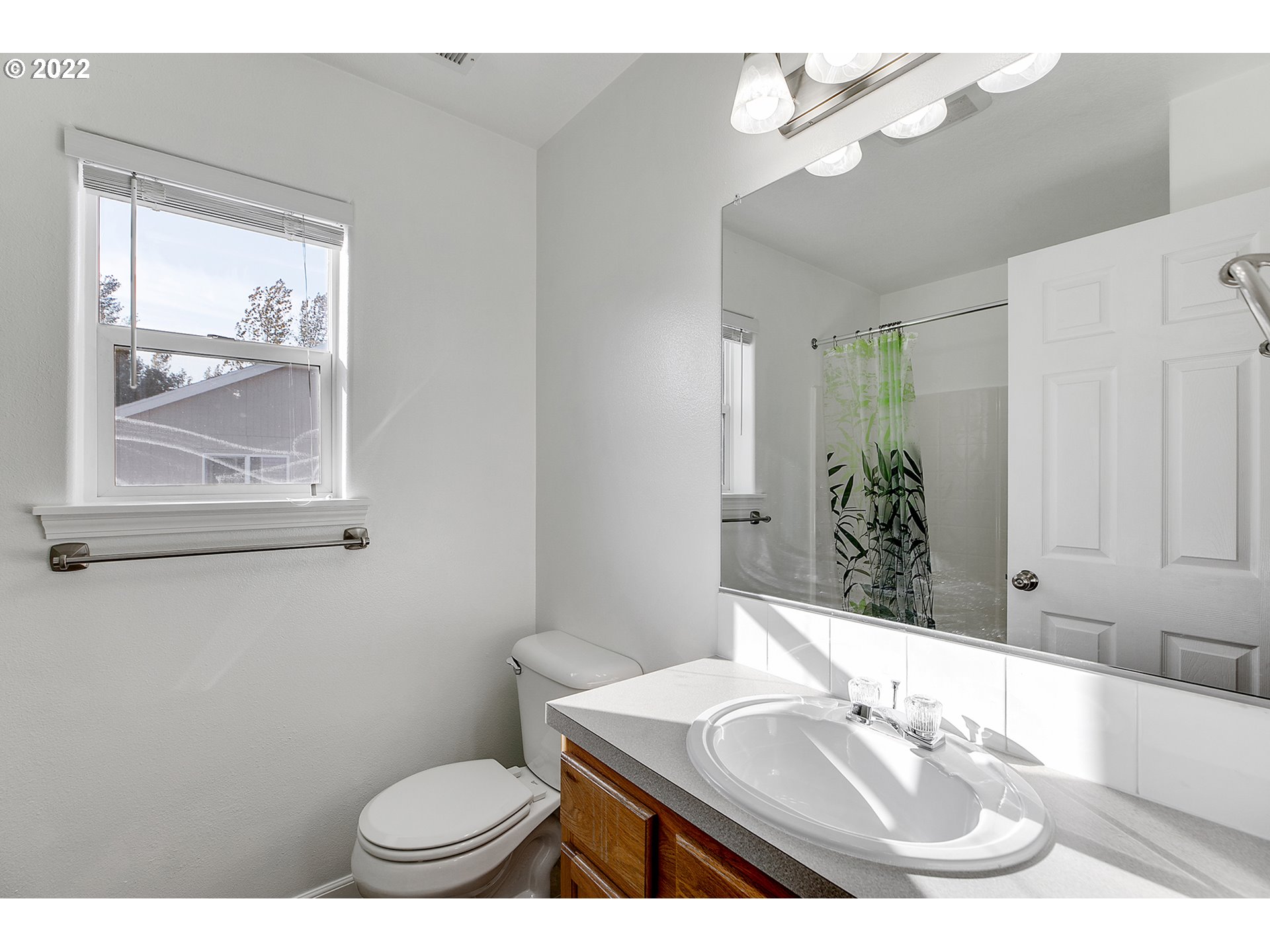 517 Northeast Mariners Loop Portland, OR 97211 - Photo 16 of 30 a bathroom with a sink a toilet a mirror and vanity