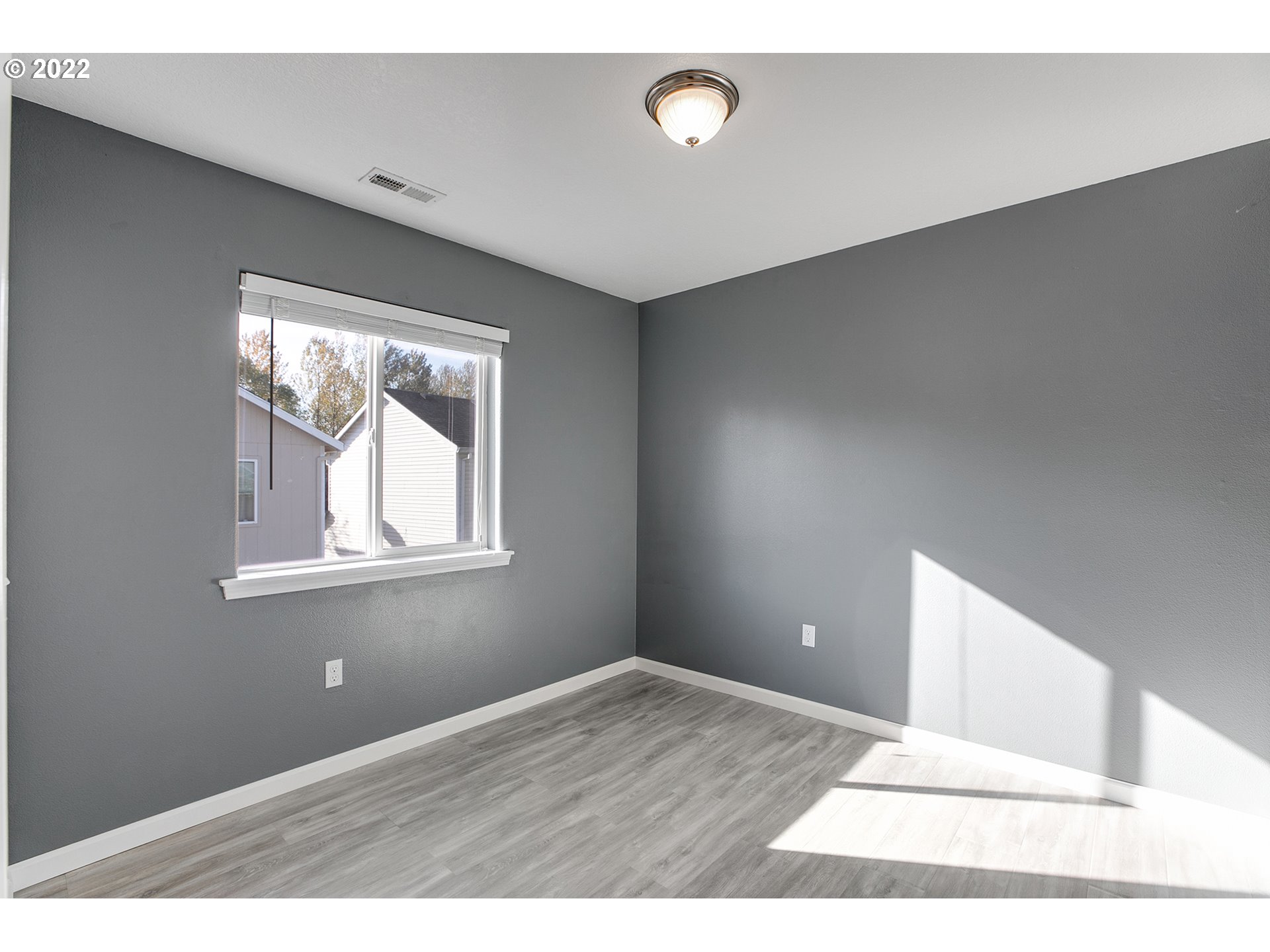 517 Northeast Mariners Loop Portland, OR 97211 - Photo 21 of 30 a view of an empty room with wooden floor and windows