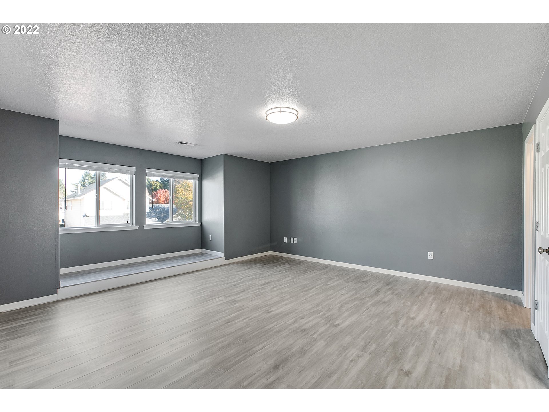 517 Northeast Mariners Loop Portland, OR 97211 - Photo 23 of 30 a view of an empty room with wooden floor and a window