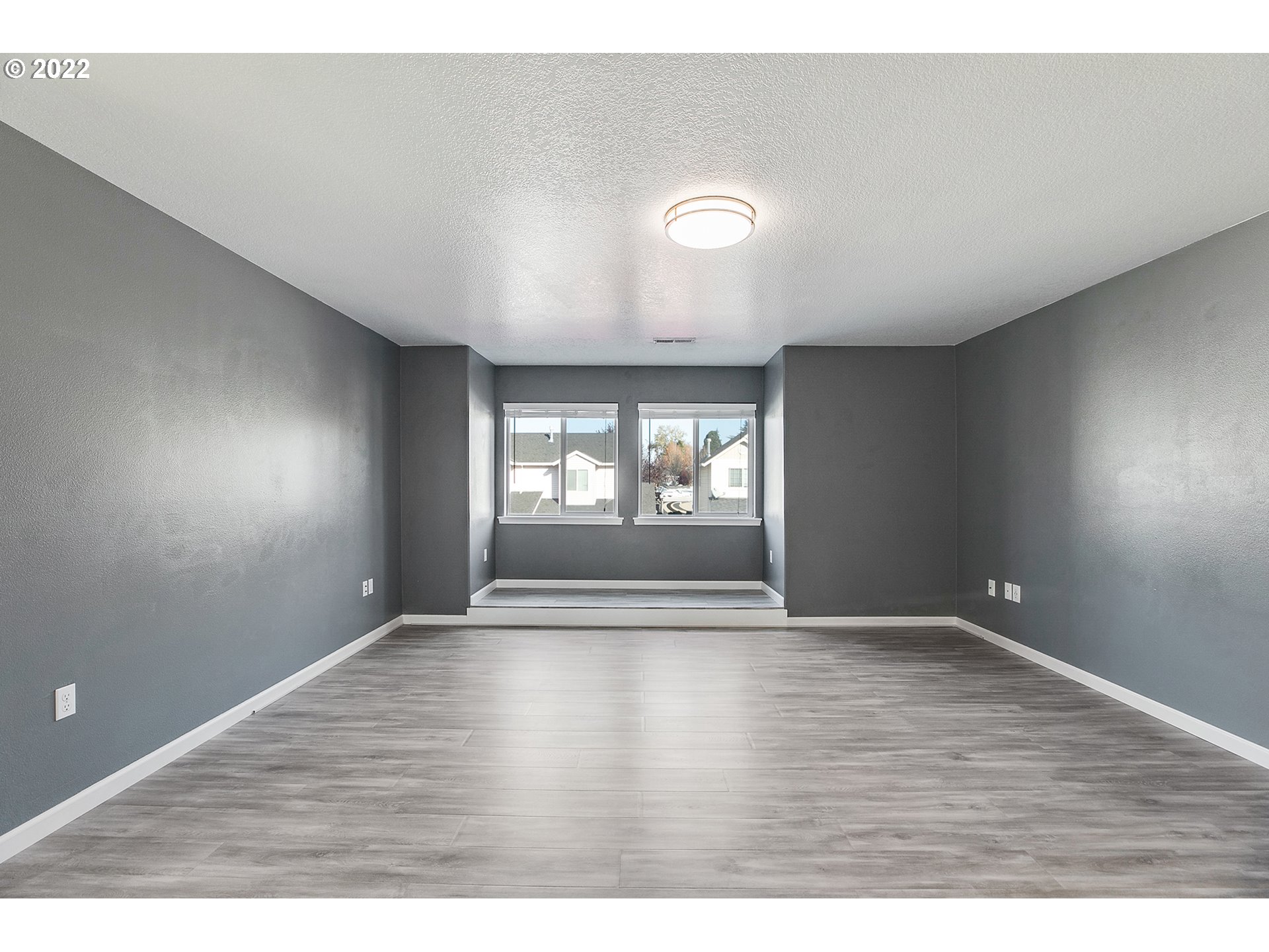 517 Northeast Mariners Loop Portland, OR 97211 - Photo 24 of 30 a view of an empty room with wooden floor and a window