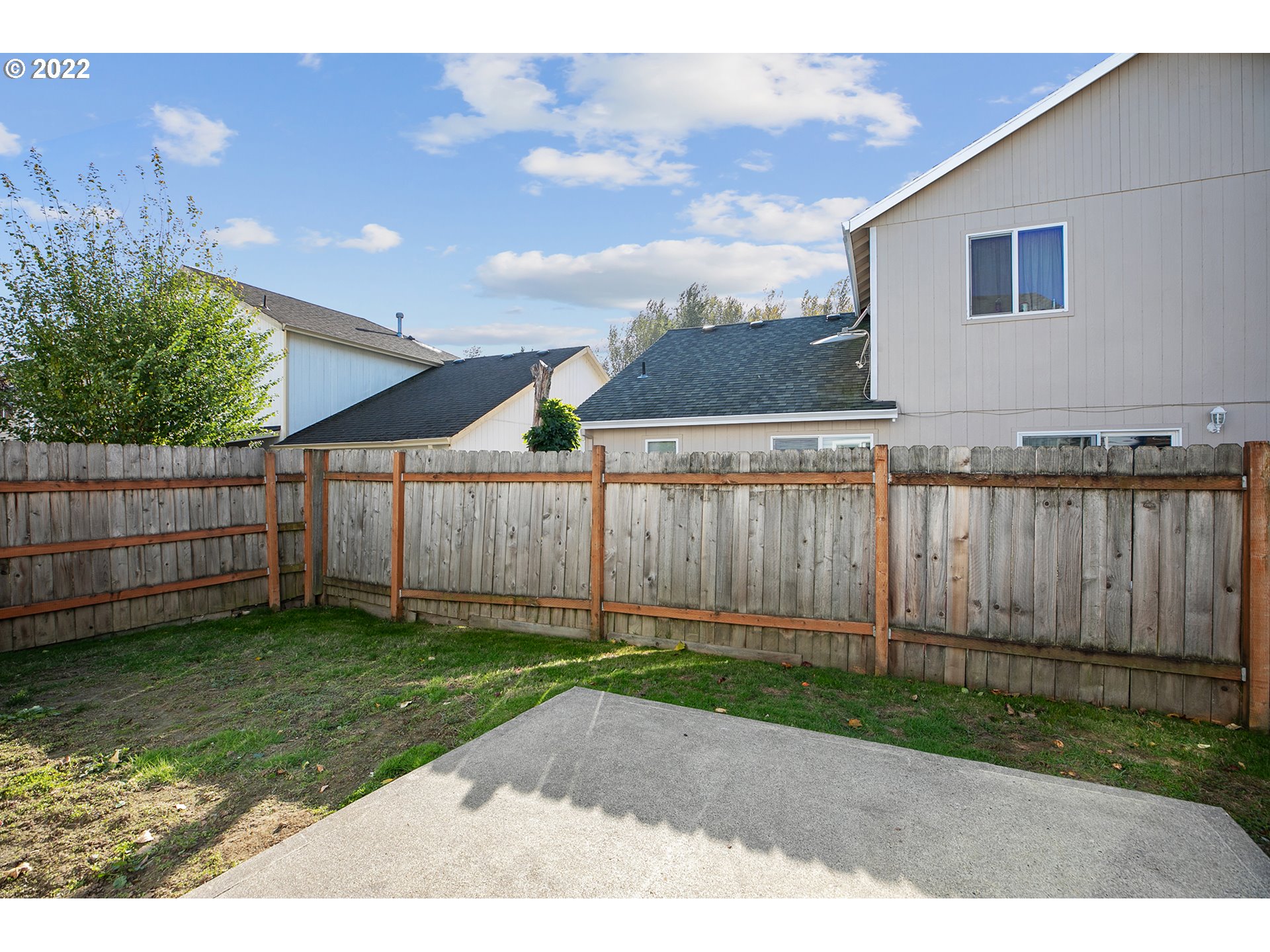 517 Northeast Mariners Loop Portland, OR 97211 - Photo 29 of 30 a backyard of a house with a small yard and wooden fence