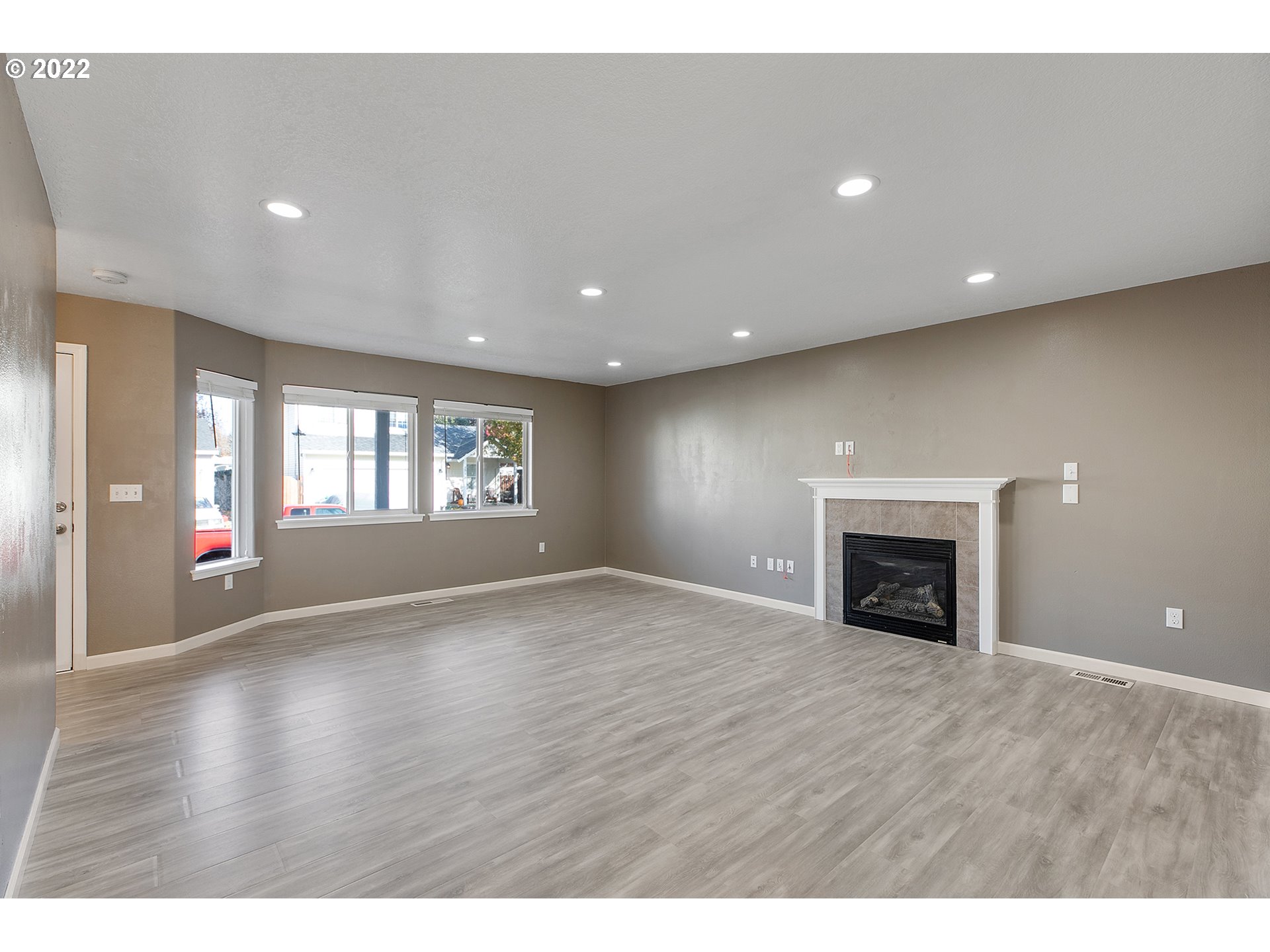 517 Northeast Mariners Loop Portland, OR 97211 - Photo 5 of 30 a view of an empty room with a window and fireplace