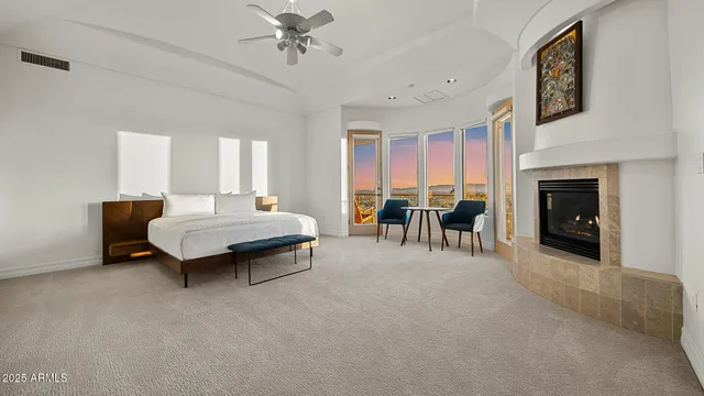 a bedroom with furniture and a fireplace