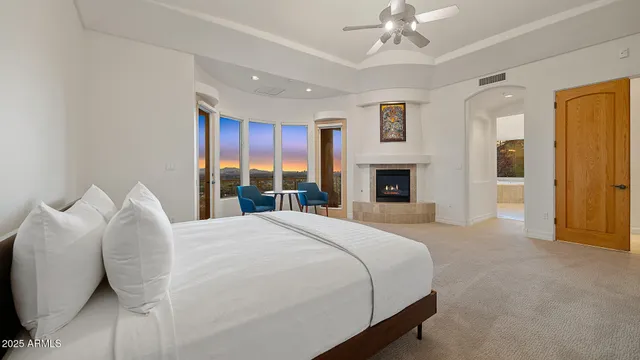 a bedroom with a large bed and a fireplace