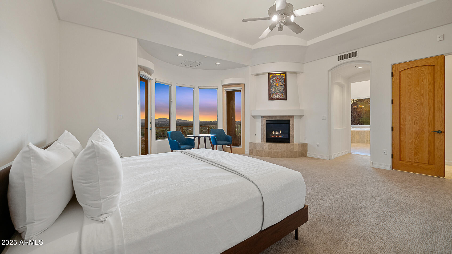 5316 East Valle Vista Road Phoenix, AZ 85018 - Photo 13 of 21 a bedroom with a large bed and a fireplace