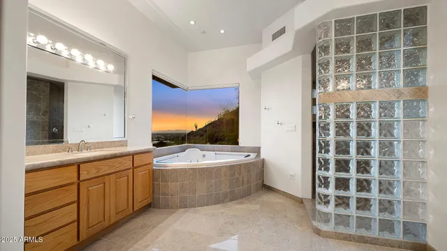 a bathroom with a tub sink and mirror