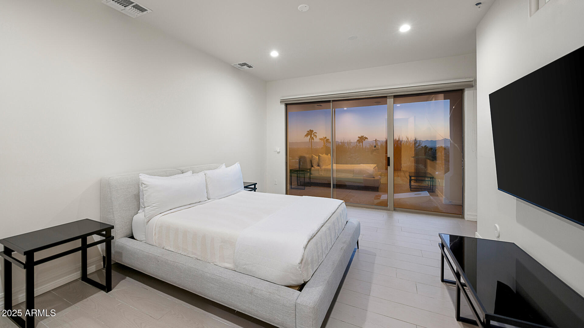 5316 East Valle Vista Road Phoenix, AZ 85018 - Photo 17 of 21 a bedroom with a bed and a flat tv screen on wall