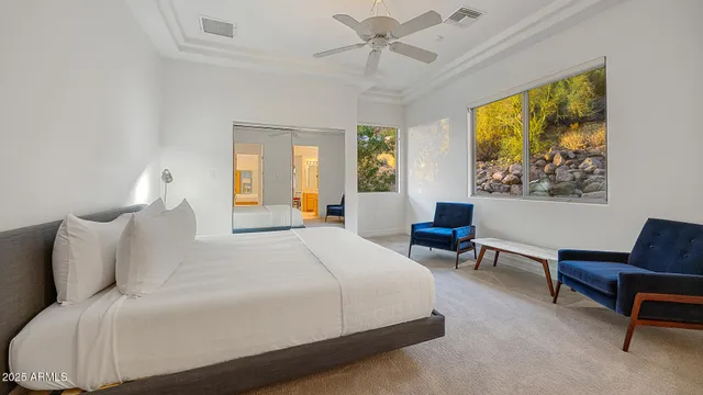 a bedroom with a bed a couch and a window