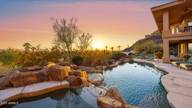 a view of roof deck with couches and wooden fence